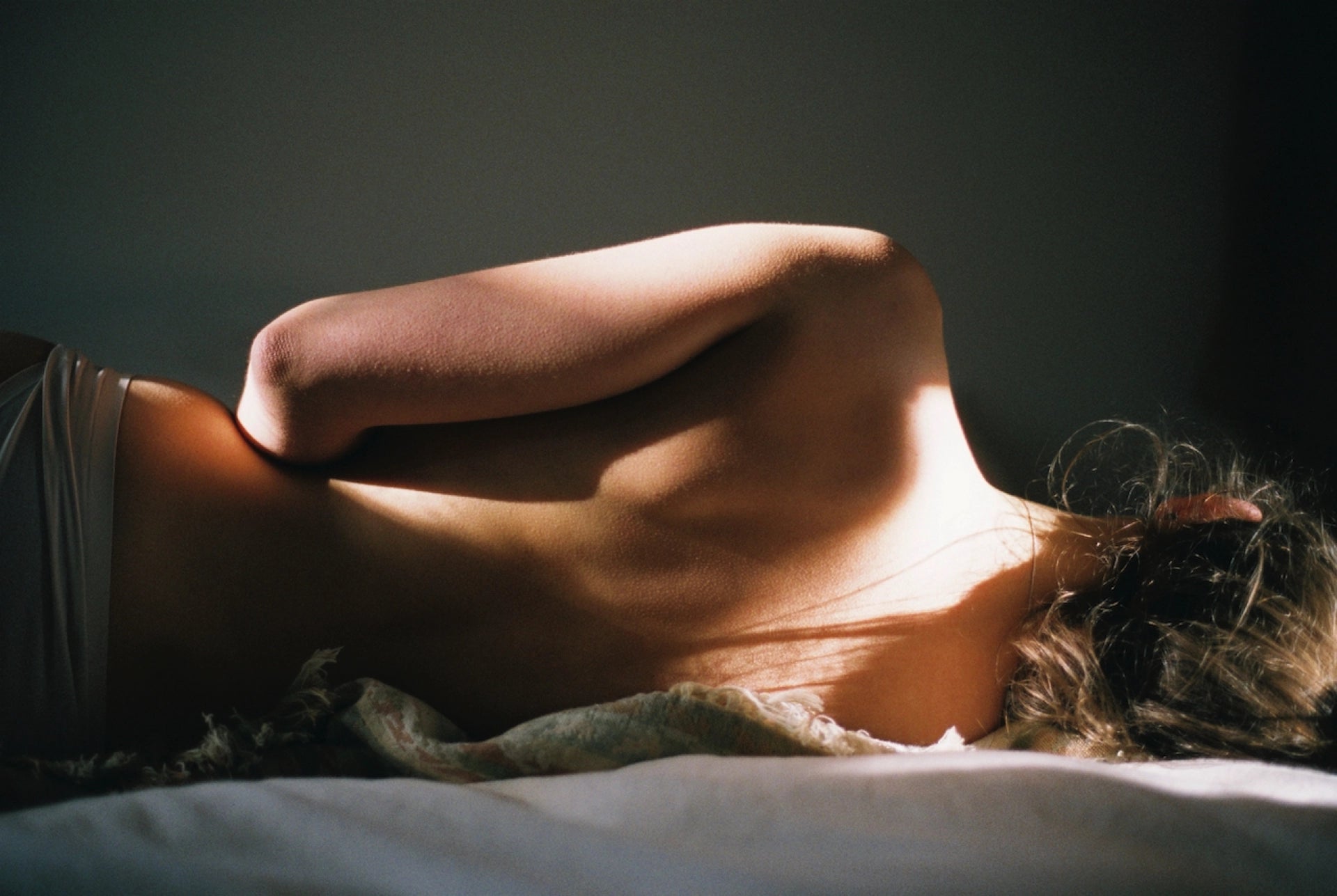 GOOD KITTY product page for 'UTI BIOME SHIELD' showing an artistic photograph of a person lying on their side with dramatic lighting highlighting the curve of their hip and waist against a dark background. Text overlay reads '30 day happiness guarantee' with an information box stating 'this works or your money back' followed by details: 'Enjoy our 30-day happiness guarantee on our supplement. If you're not completely satisfied, contact us within 30 days of delivery for a refund of the price of the supplemen