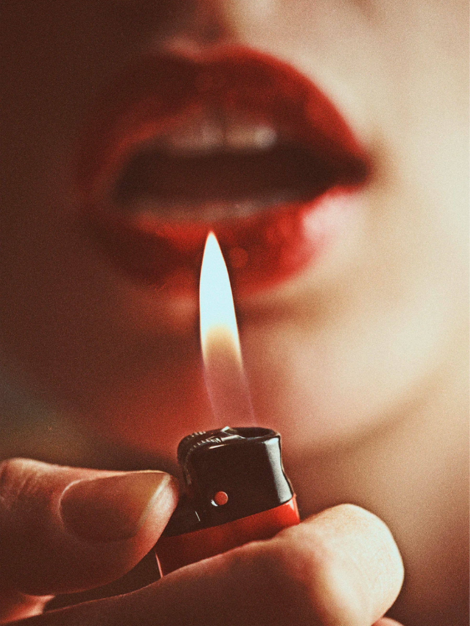 Close-up of red lips with a lit lighter flame in the foreground. The word 'prevention' appears vertically along the left side with a 'shop now' button below, creating a sensual yet empowering aesthetic.