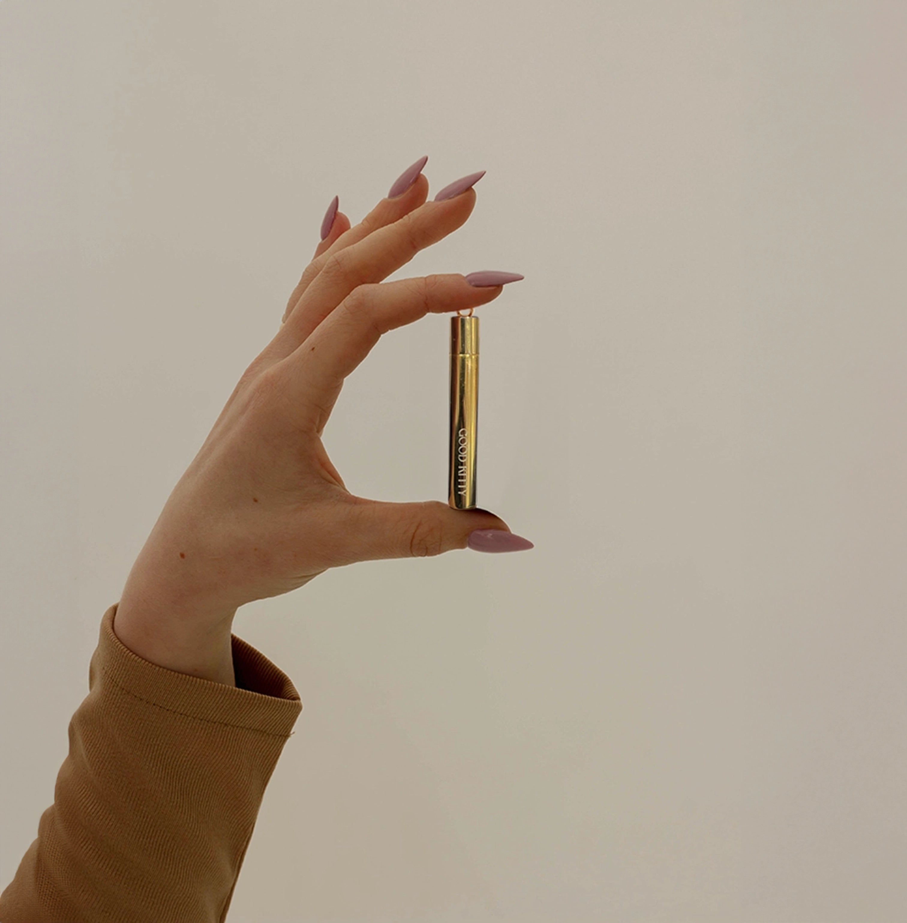 Meghan Carozza designed the sophisticated Overnighter pendant—a statement piece in 24k gold-plated stainless steel that combines luxury with functionality for effortless day-to-night versatility. The artistic photoshoot, styled by Carozza herself, showcases the pendant's elegant design against curated backgrounds that highlight its refined aesthetic.