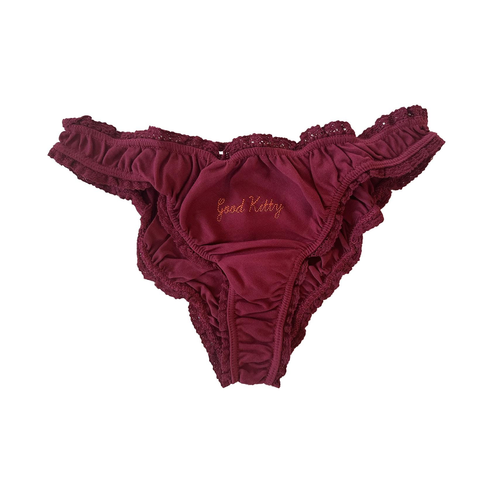 Burgundy lace-trimmed underwear with "Good Kitty" embroidered in gold script across the front. The feminine lingerie piece is displayed against a transparent checkered background.
