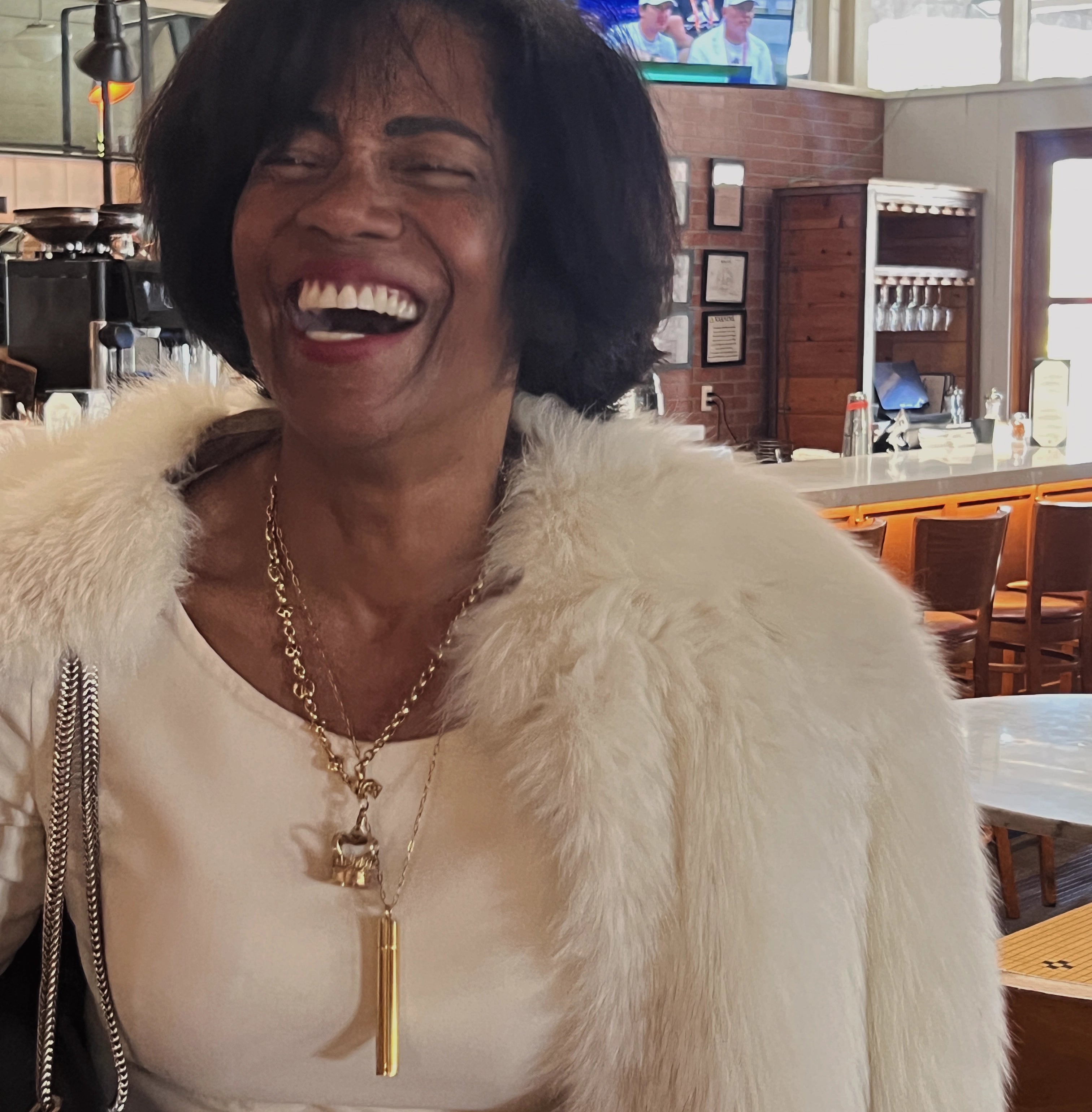 Good Kitty's overnighter 24k pill stash pendant designed by Meghan Carozza on a smiling customer (Twila) showcasing elevated UTI prevention and women's sexual wellness.