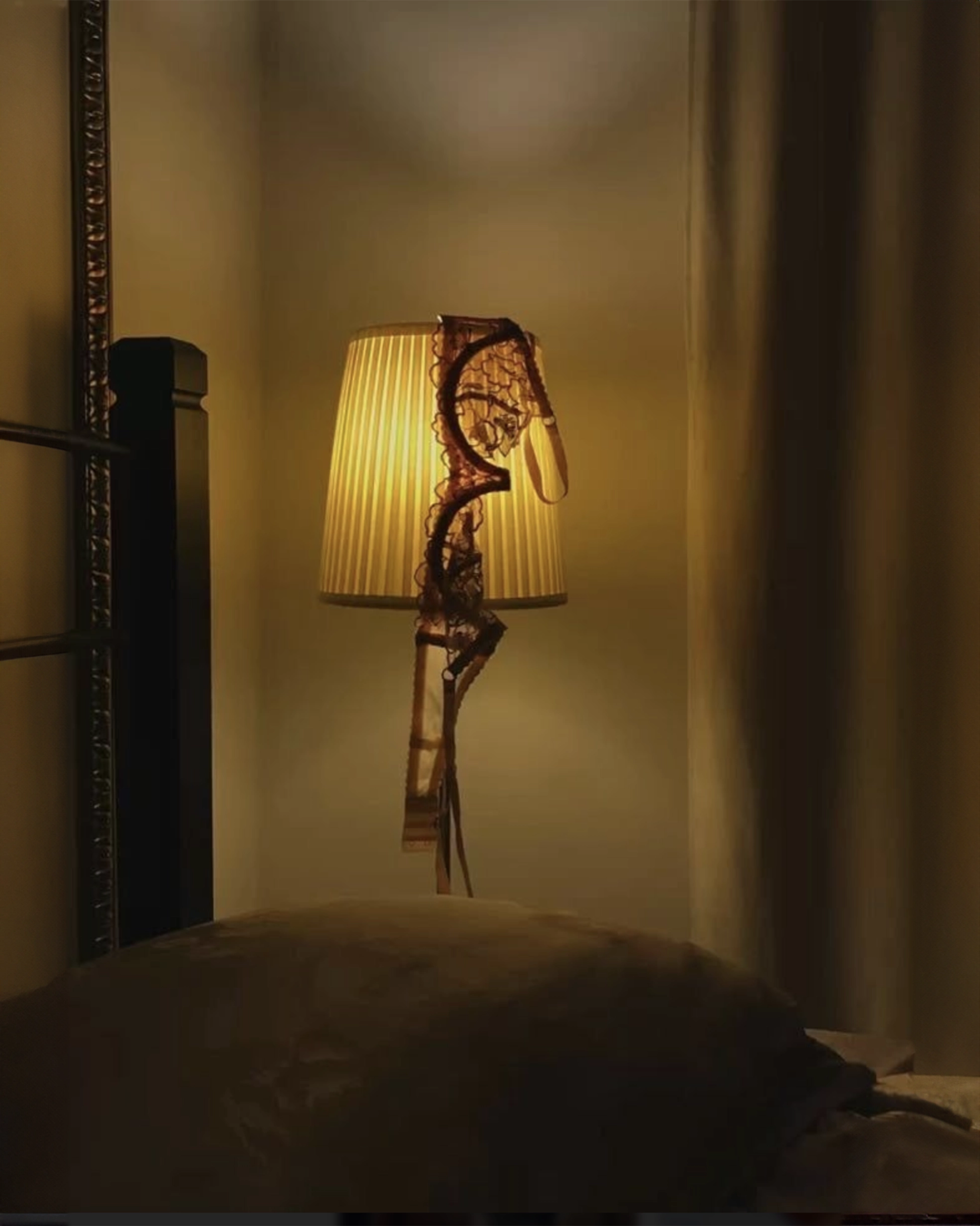 Decorative floor lamp with a unique design in a dimly lit room.