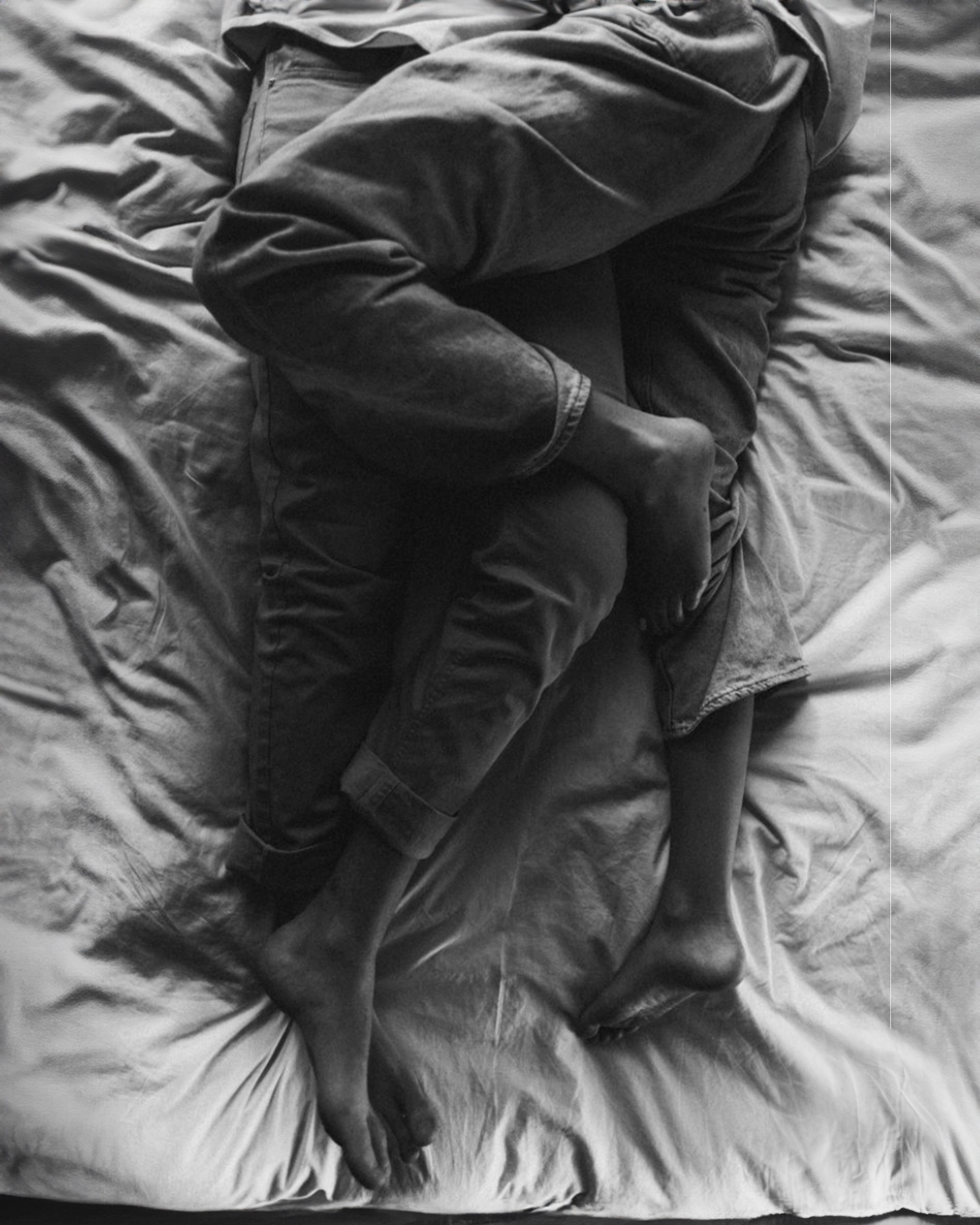 Person wrapped in a blanket on a bed