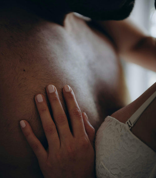 This is a close-up image showing what appears to be hands or intimate contact, with text overlay that reads "uti-free intimacy in one pill" and a subheading "Physician-formulated & scientifically-proven UTI prevention for your daily & intimate regimen." There's also a "shop now" button at the bottom.
