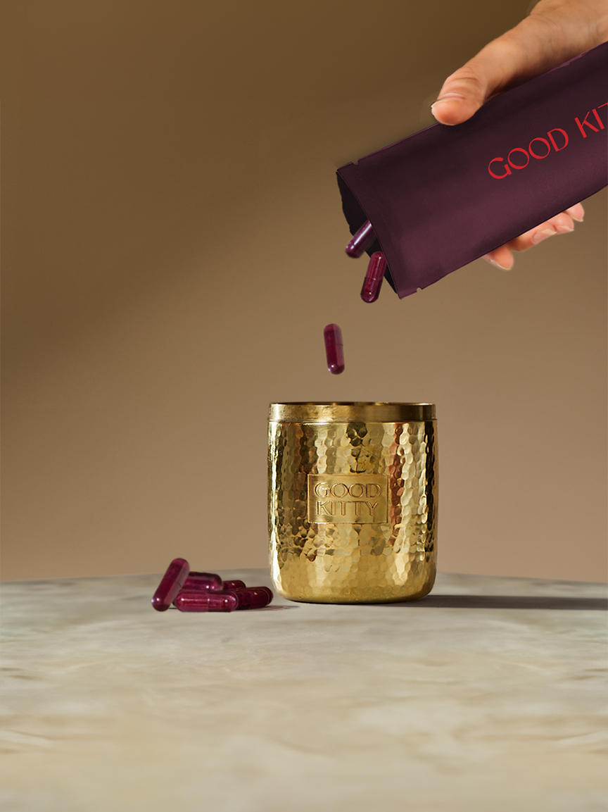 Elegantly styled photoshoot featuring luxurious brass-clad stainless steel canister designed by Meghan Carozza for sustainable Good Kitty UTI prevention and women's sexual wellness